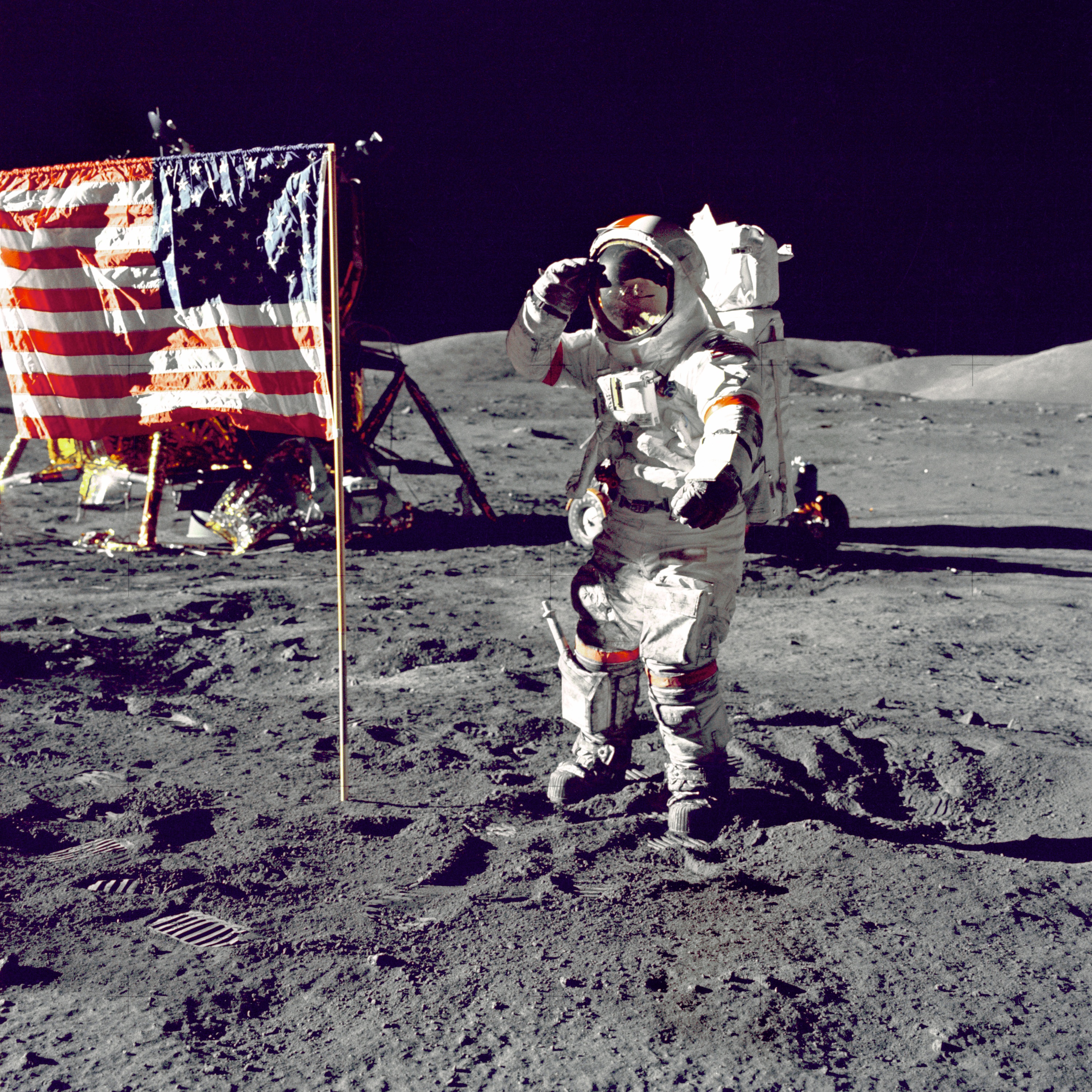 Photo of astronautc next to USA flag on the moon